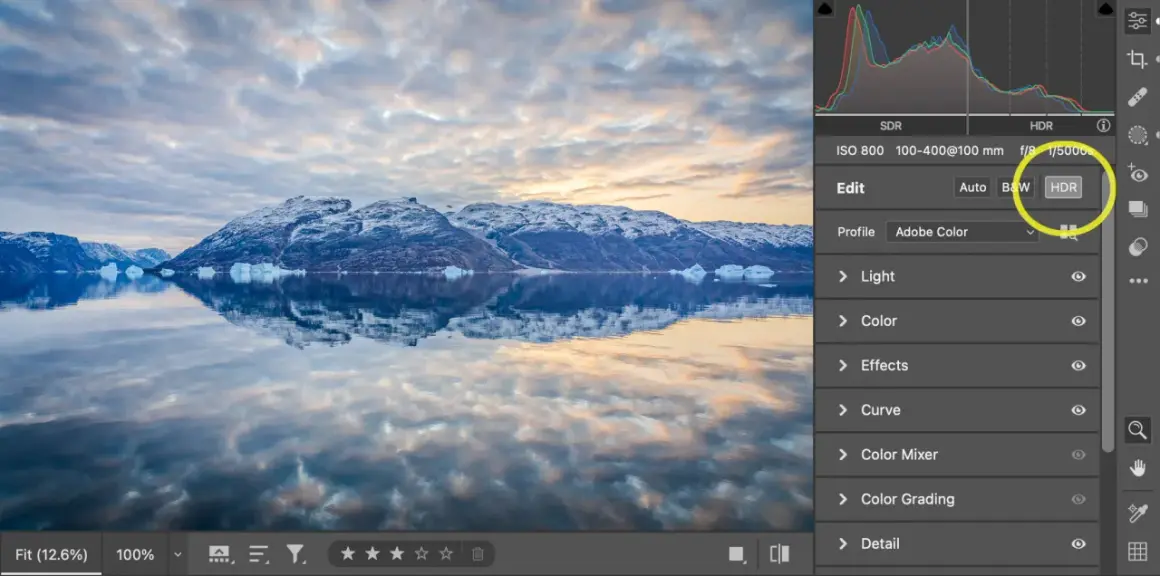 Paisaje ártico con montañas nevadas y reflejos en el agua. Se muestra la interfaz de Photoshop con la opción HDR seleccionada.