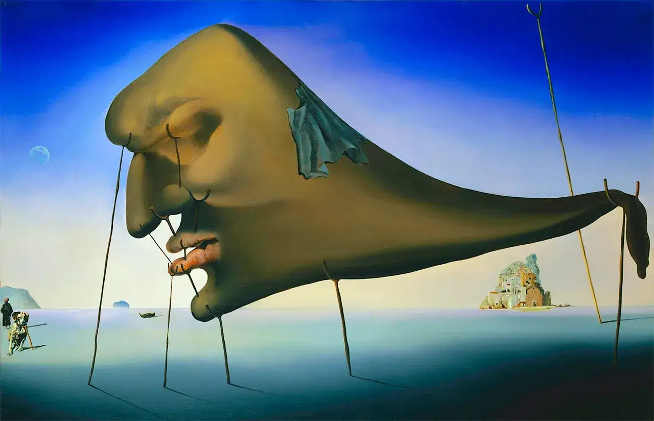 El rostro gigante y blando de Dalí, sostenido por finos hilos, evoca la sensación de la fotografia mas cara del mundo. Un paisaje onírico con una isla rocosa.